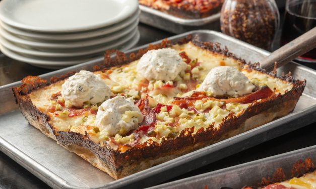 Delight in a cheesy, crispy masterpiece topped with savory goodness!