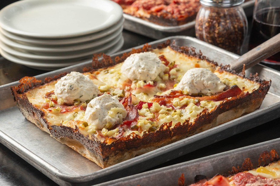 Delight in a cheesy, crispy masterpiece topped with savory goodness!