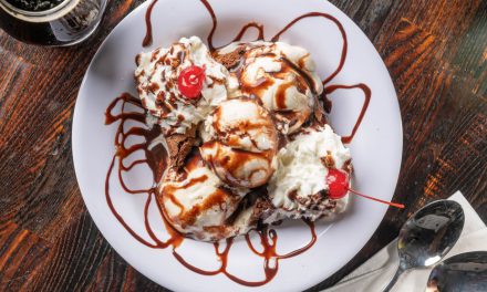 Indulge in a heavenly dessert drizzled with chocolate and topped with cherries!