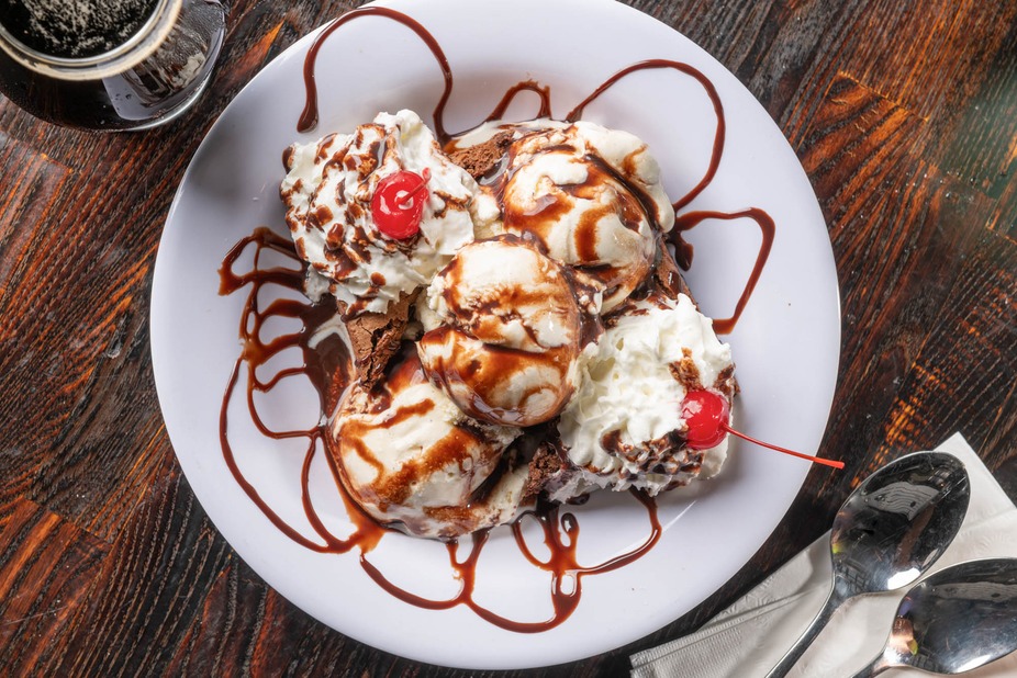 Indulge in a heavenly dessert drizzled with chocolate and topped with cherries!